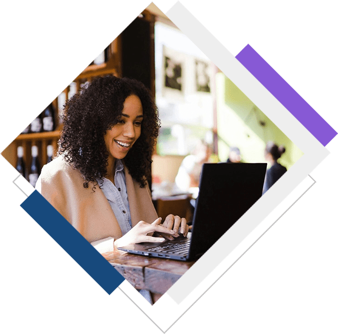 A woman sitting at a table with a laptop.