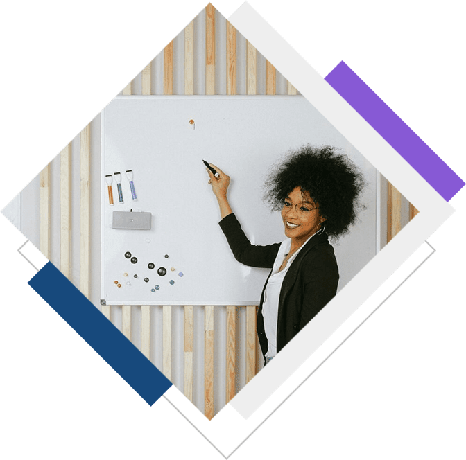 A woman standing in front of a whiteboard.